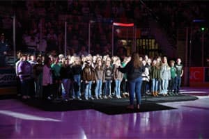 A choir performing the National Anthem at GIANT Center,