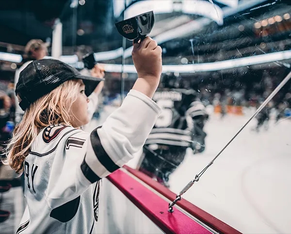 A young fan cheering at a Hershey Bears game.