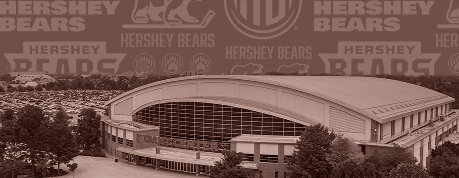 Exterior photo of GIANT Center with a variety of Hershey Bears wordmarks and logos in the background.