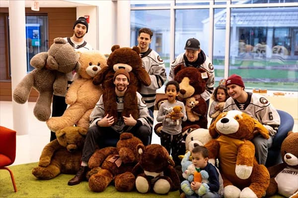 Bears players and kids surrounded by teddy bears at GIANT Center.