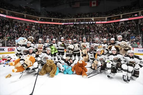 Hershey Bears players with stuffed animals on the ice during the Teddy Bear Toss at GIANT Center.
