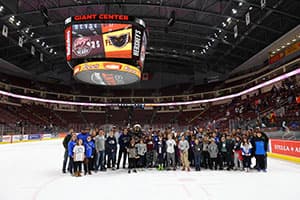 Photo of a corporate group on the ice at GIANT Center.