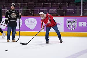 A man trying his hand at the post game slapshot challenge following a Hershey Bears game.